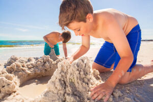 kids playing making sand castles on the coast of mexico beach florida