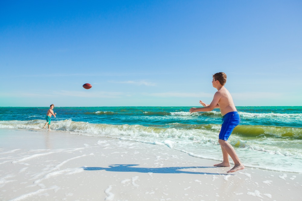 Boy playing catch on beach at Mexico Beach