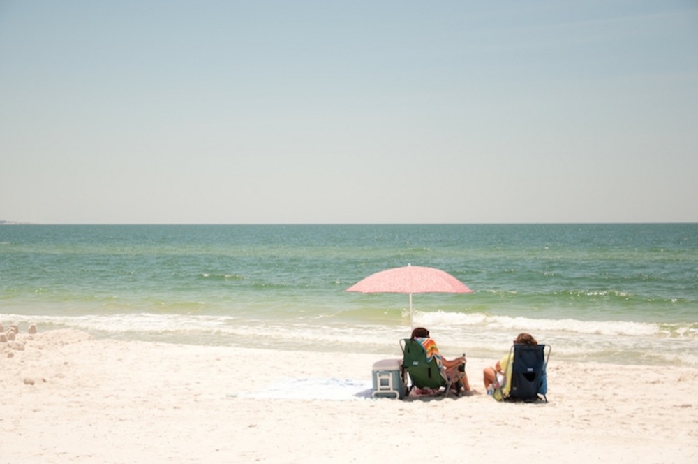 Umbrella on Mexico Beach Florida; beach goers; sitting at the beach