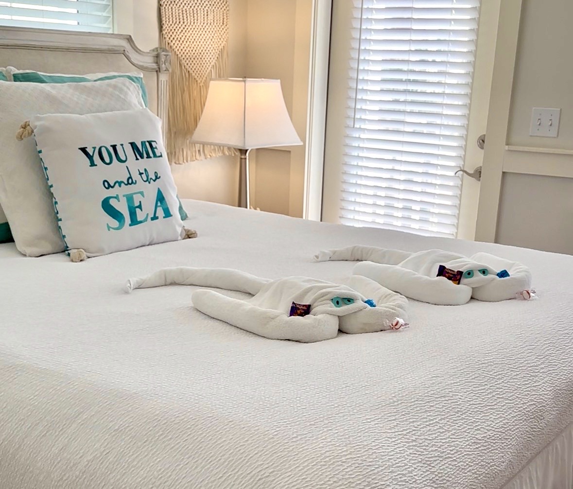 a bright pink store with merchandise outside and an open sign